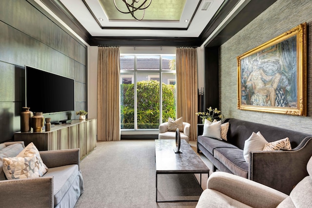 living room with a raised ceiling and carpet floors