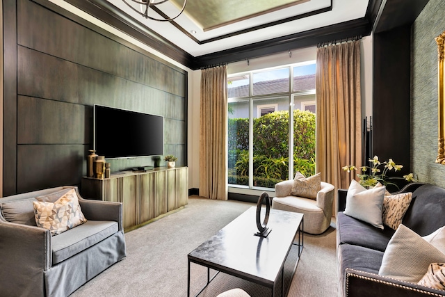 living room featuring plenty of natural light, light colored carpet, crown molding, and a tray ceiling