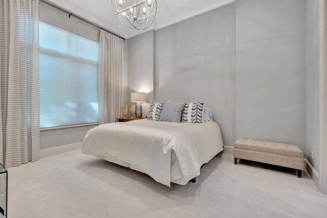 carpeted bedroom with ornamental molding and an inviting chandelier