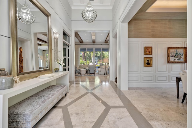 corridor with a high ceiling and an inviting chandelier