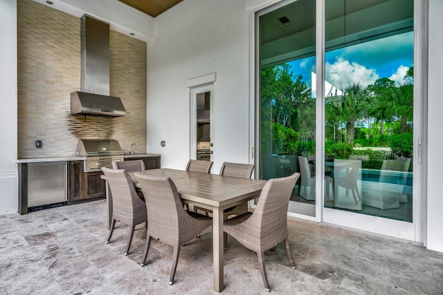 view of patio featuring a grill, sink, and an outdoor kitchen