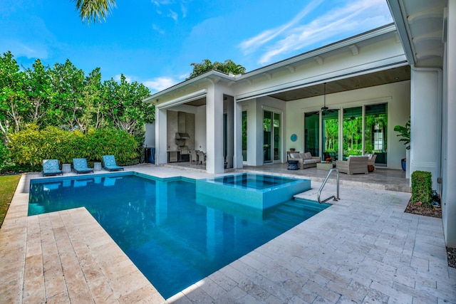 view of swimming pool with an in ground hot tub, ceiling fan, a patio, and an outdoor hangout area