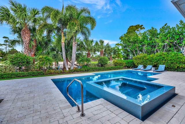 view of swimming pool with a patio area and an in ground hot tub