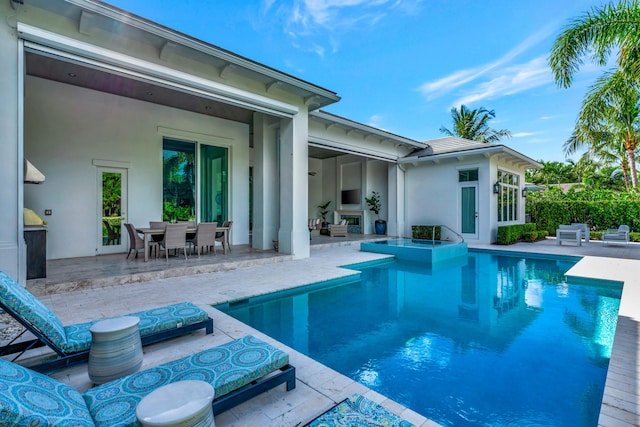 view of swimming pool with a patio area and a fireplace