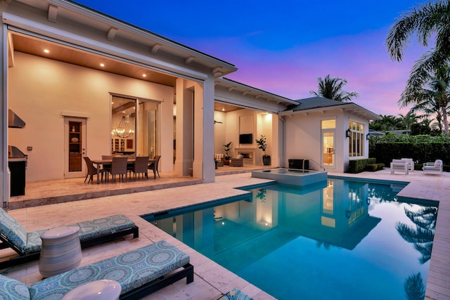 view of pool featuring an in ground hot tub and a patio area