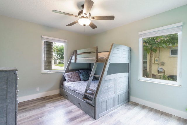 bedroom with light hardwood / wood-style flooring and ceiling fan