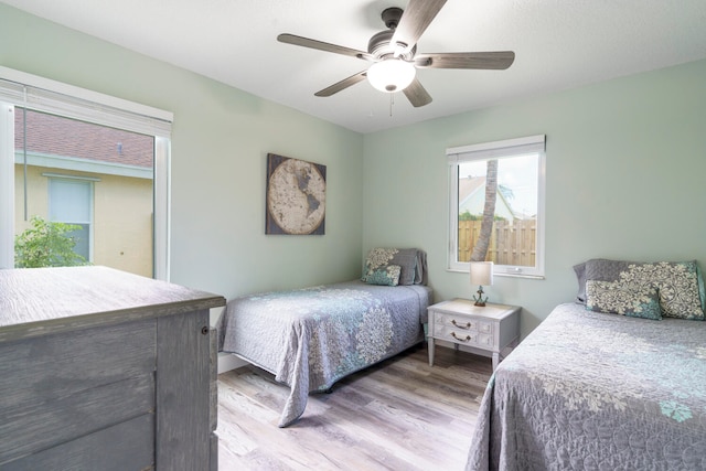 bedroom with ceiling fan and light wood-type flooring