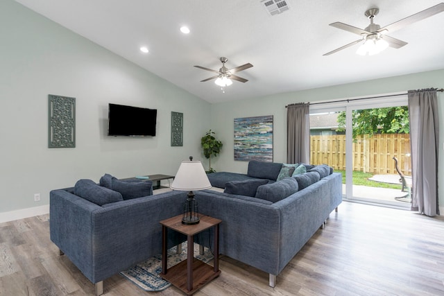 living room with light wood-type flooring, vaulted ceiling, and ceiling fan