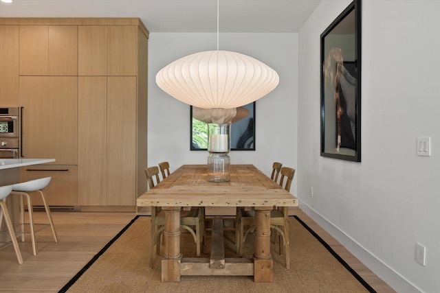 dining area with light wood-type flooring