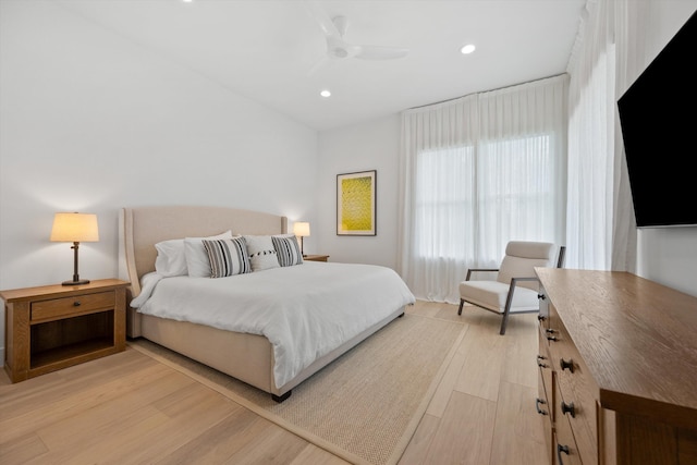 bedroom with light hardwood / wood-style floors and ceiling fan