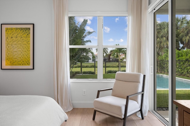 bedroom featuring light hardwood / wood-style floors and multiple windows