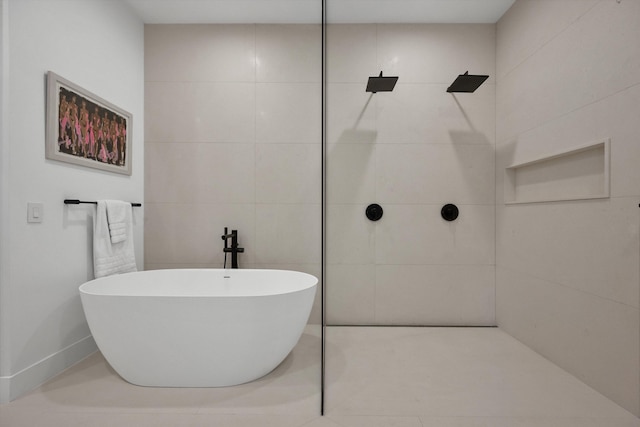 bathroom featuring tile walls and shower with separate bathtub