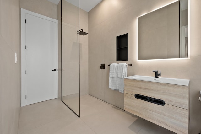 bathroom featuring tile patterned floors, vanity, and walk in shower