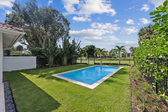 view of pool with a lawn