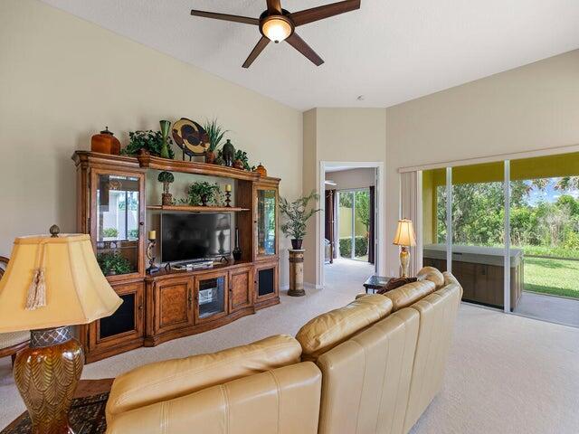 bedroom with ceiling fan and light carpet