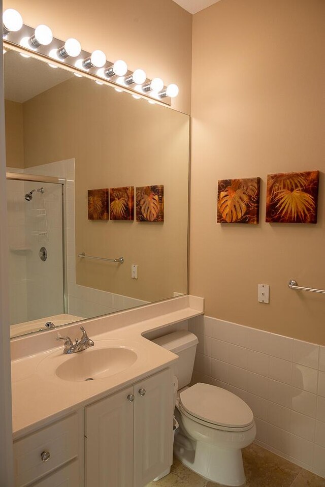 full bath featuring toilet, a bath, and vanity