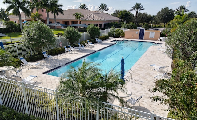 community pool featuring a patio area and fence