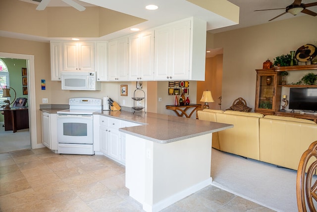 kitchen with light colored carpet, kitchen peninsula, white appliances, and white cabinetry