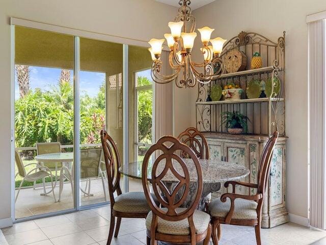 dining area with an inviting chandelier and light tile patterned floors