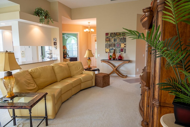 living room with light colored carpet, baseboards, and an inviting chandelier