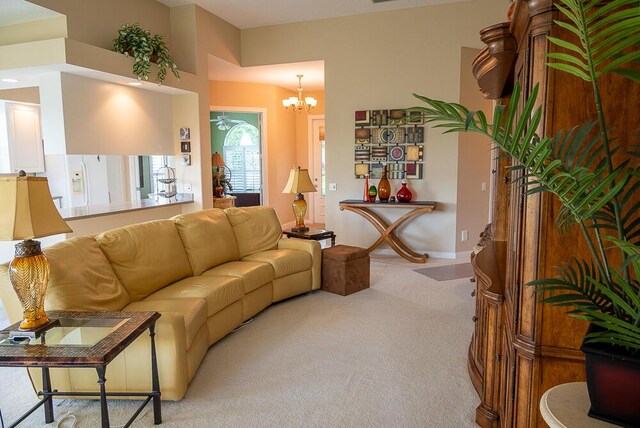 living room with carpet and an inviting chandelier