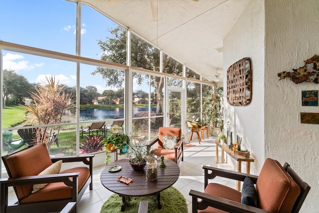 sunroom / solarium featuring a water view, ceiling fan, and a healthy amount of sunlight