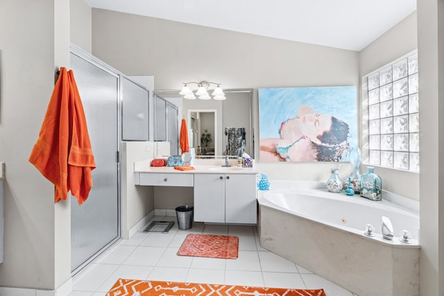 bathroom featuring shower with separate bathtub, vanity, vaulted ceiling, and tile patterned floors