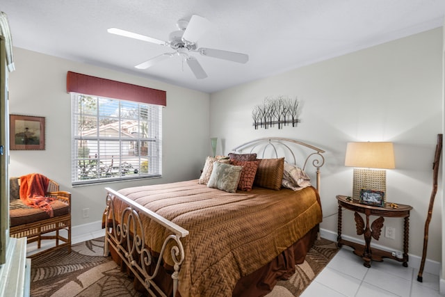 tiled bedroom featuring ceiling fan