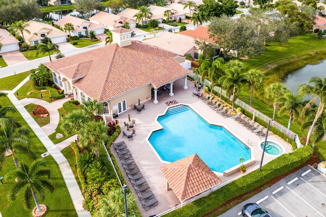 view of swimming pool with a water view and a patio