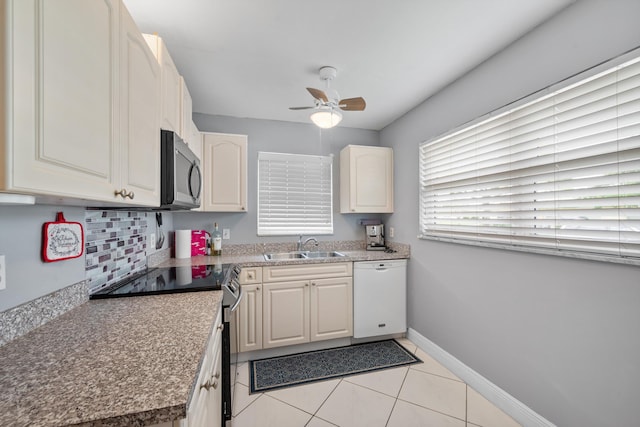 kitchen featuring appliances with stainless steel finishes, tasteful backsplash, ceiling fan, sink, and light tile patterned floors