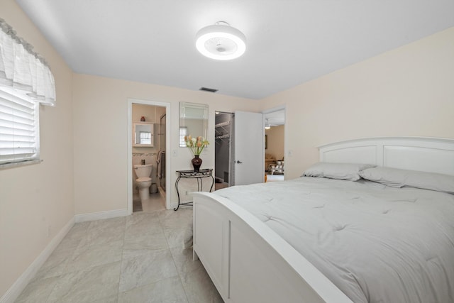 bedroom featuring ensuite bathroom, a spacious closet, and a closet