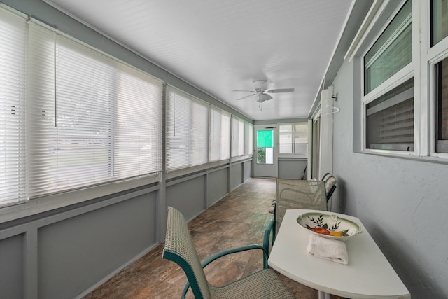 sunroom / solarium featuring ceiling fan