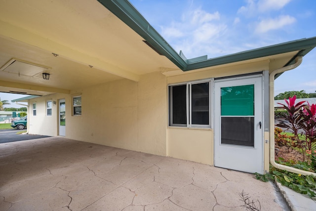 entrance to property featuring a patio