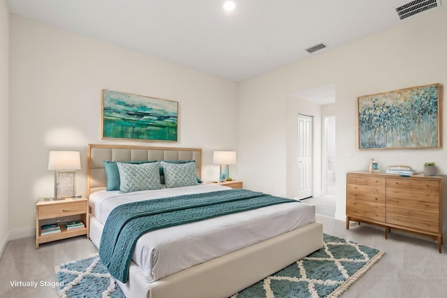 carpeted bedroom with a closet, visible vents, ensuite bathroom, and baseboards