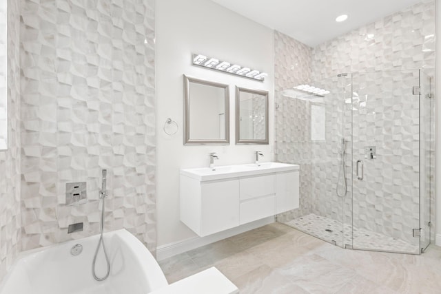 bathroom with double vanity, a sink, a shower stall, and a washtub