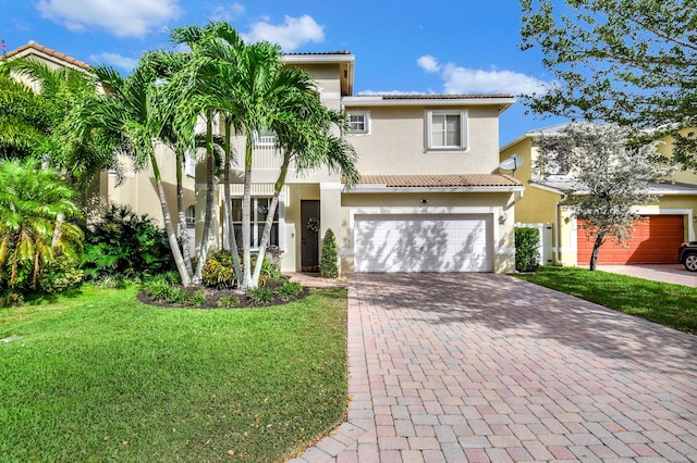 mediterranean / spanish home with a front yard and a garage