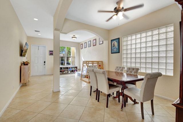 tiled dining space featuring ceiling fan