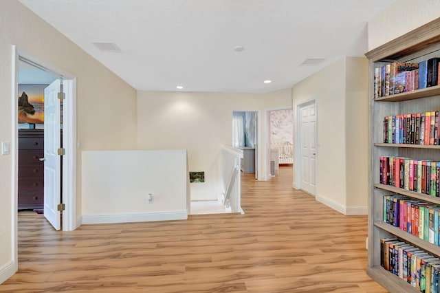 hallway with light hardwood / wood-style flooring