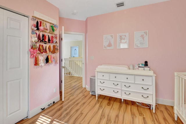 bedroom with a closet and light hardwood / wood-style floors