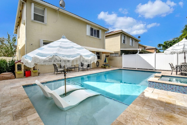 view of swimming pool featuring an in ground hot tub and a patio area