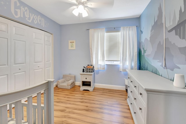 bedroom with light hardwood / wood-style flooring, ceiling fan, and a closet