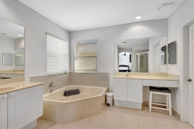 bathroom with tile patterned floors, a textured ceiling, vanity, ceiling fan, and plus walk in shower