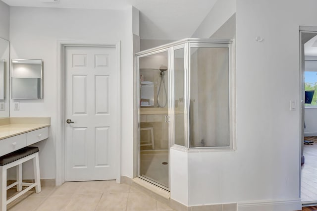 bathroom with tile patterned floors, vanity, and an enclosed shower