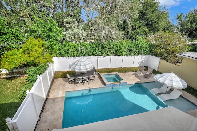 view of pool with an in ground hot tub and a patio area