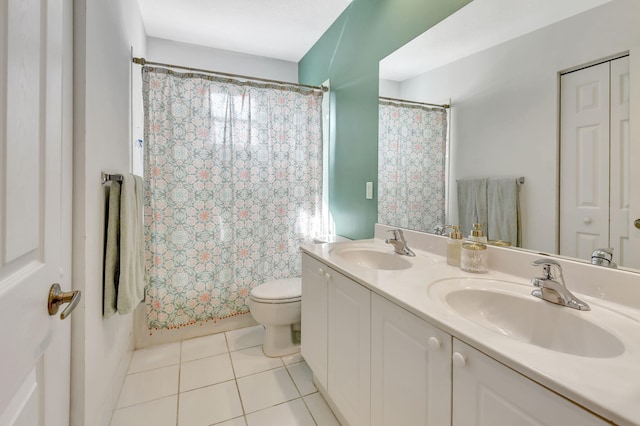 bathroom featuring tile patterned flooring, vanity, and toilet