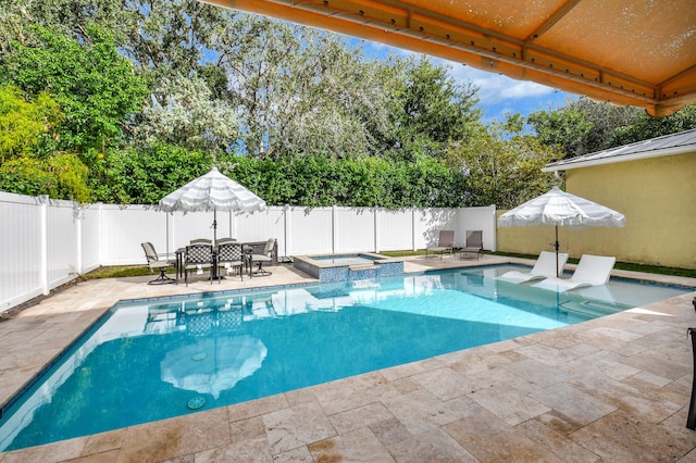 view of swimming pool with an in ground hot tub and a patio