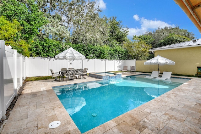 view of pool featuring a patio area and an in ground hot tub