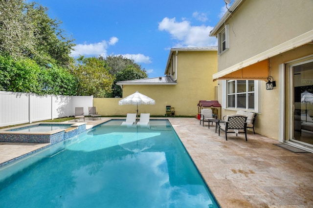 view of swimming pool featuring an in ground hot tub and a patio