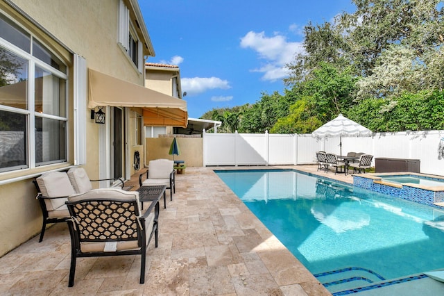 view of swimming pool featuring an in ground hot tub and a patio area