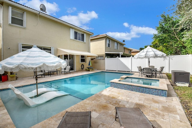 view of swimming pool with a patio area and an in ground hot tub